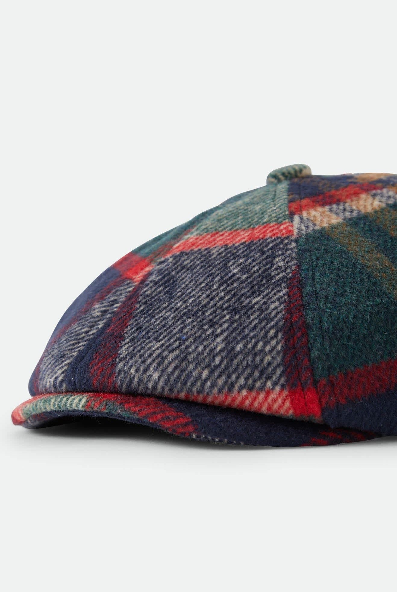 Unisex Brood Newsboy Cap in the color Navy/Green/Red/Cream - Additional Laydown image