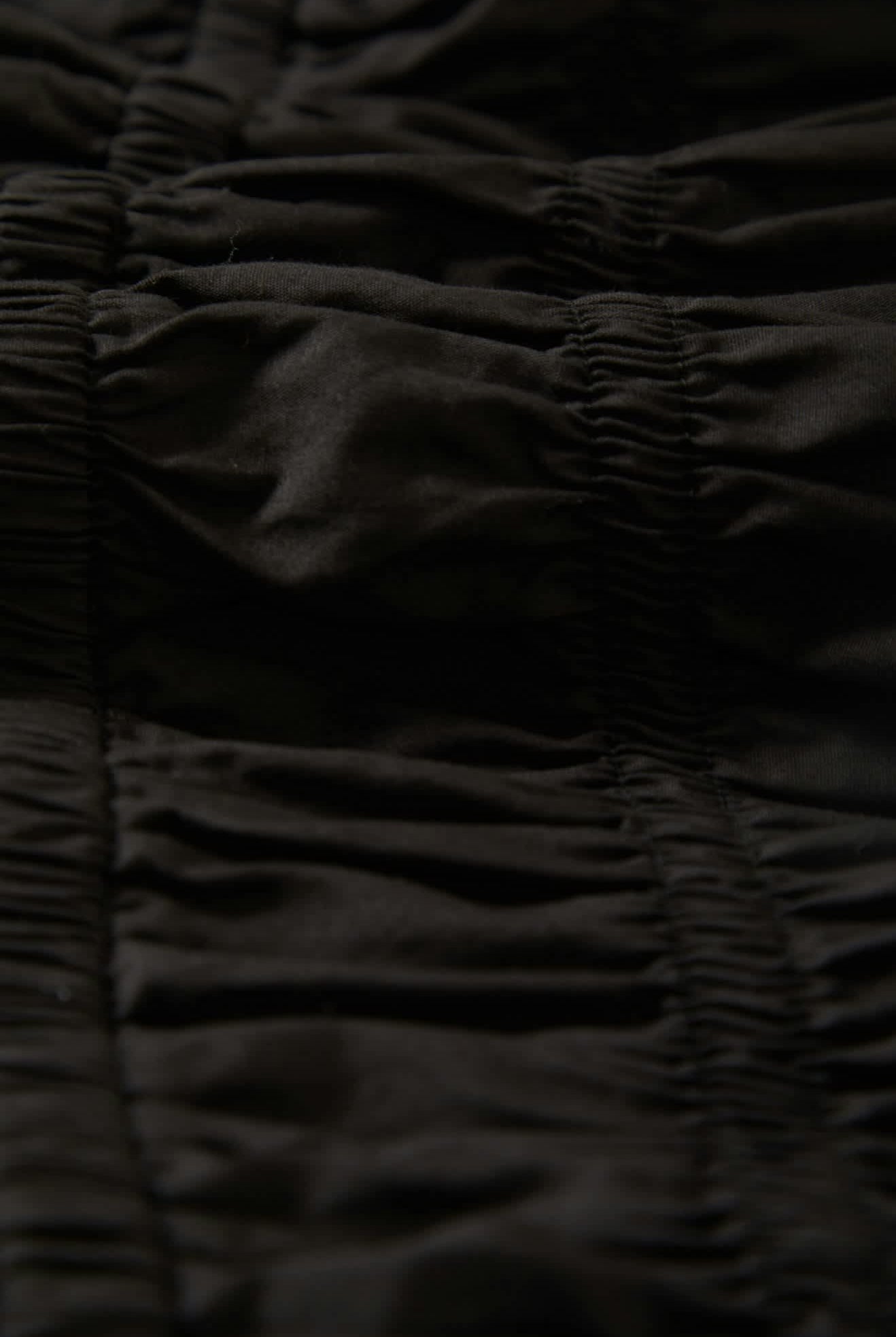 Women's Eden Smocked Jumpsuit in the color Black - Additional Laydown image