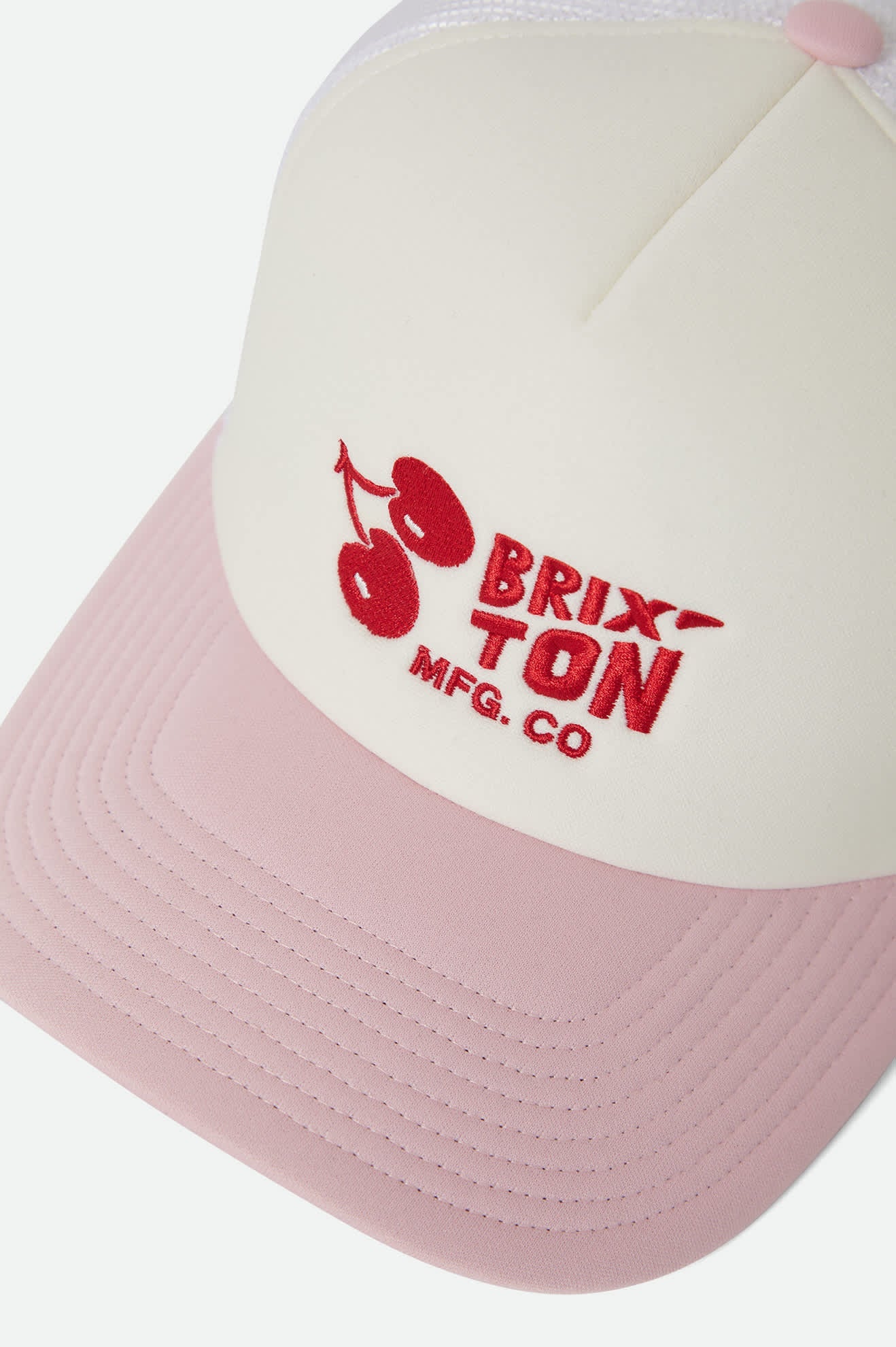 Women's Cherry NetPlus Trucker Hat in the color Off White/Pink - Additional Laydown image