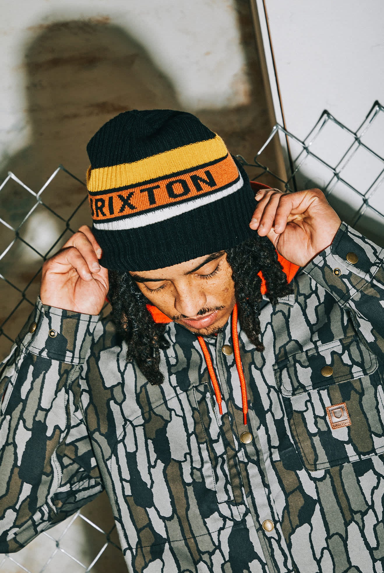 Men's Rainier Striped Beanie in the color Black/Yellow/Orange - Men's Lifestyle image