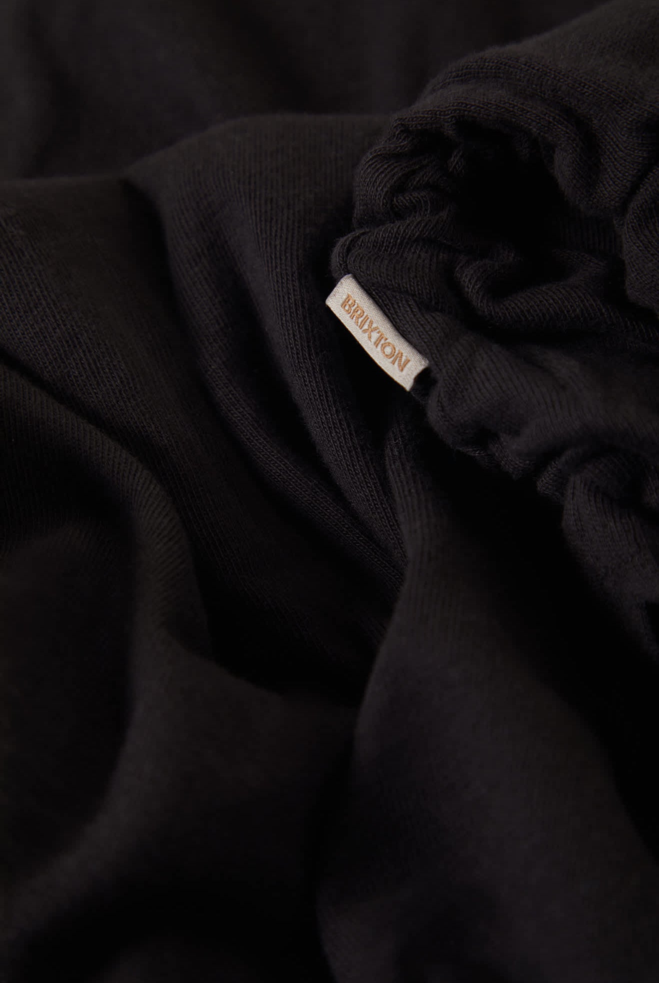 Women's Carefree Organic Garment Dye Cinch T-Shirt in the color Black - Additional Laydown image