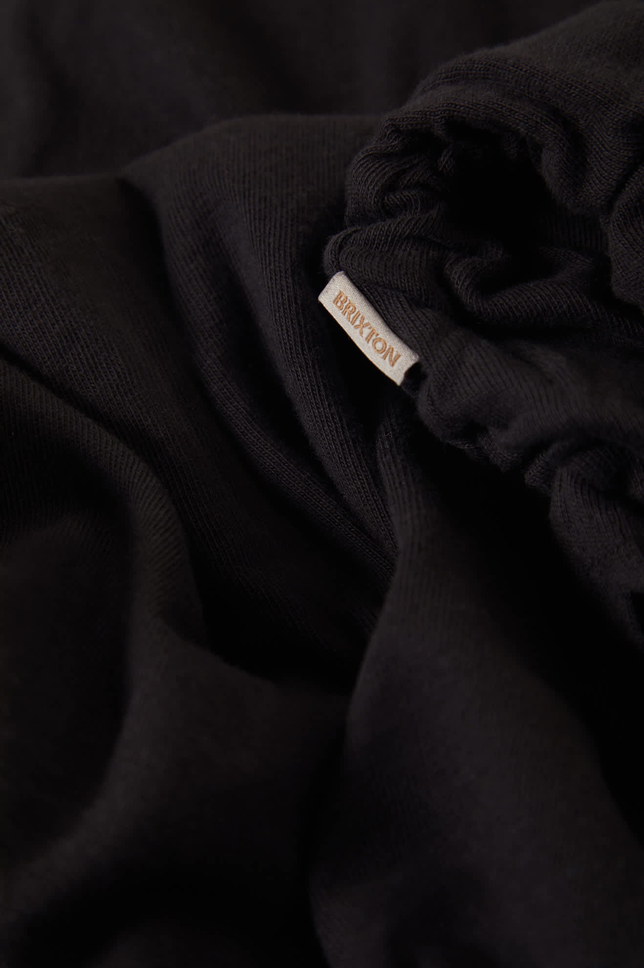 Women's Carefree Organic Garment Dye Cinch T-Shirt in the color Black - Additional Laydown image