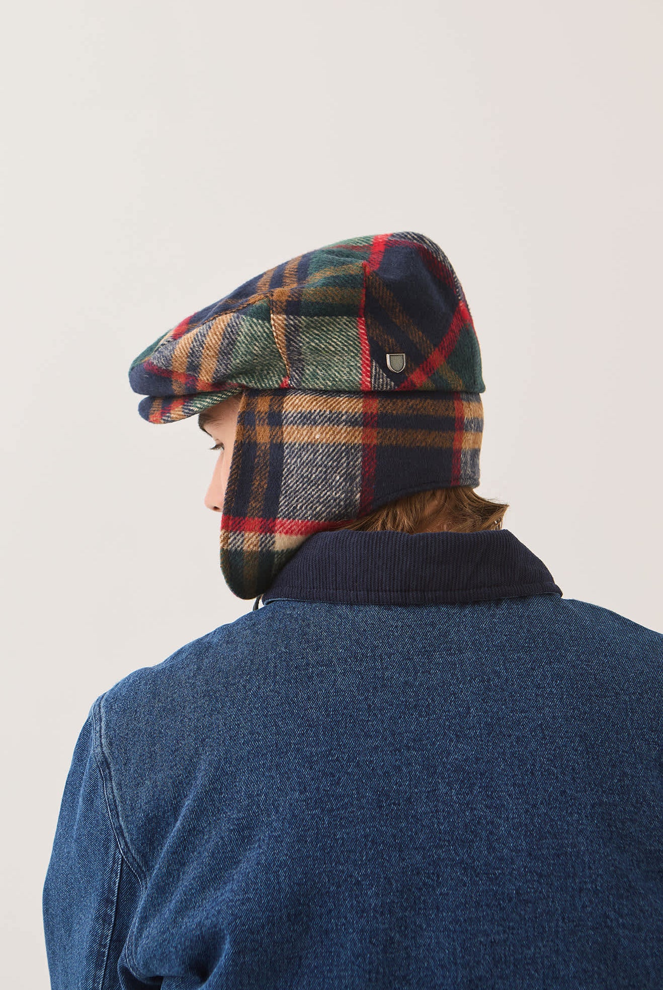 Unisex Barrel Earflap Snap Cap in the color Navy/Green/Red/Cream - Men's Back View
