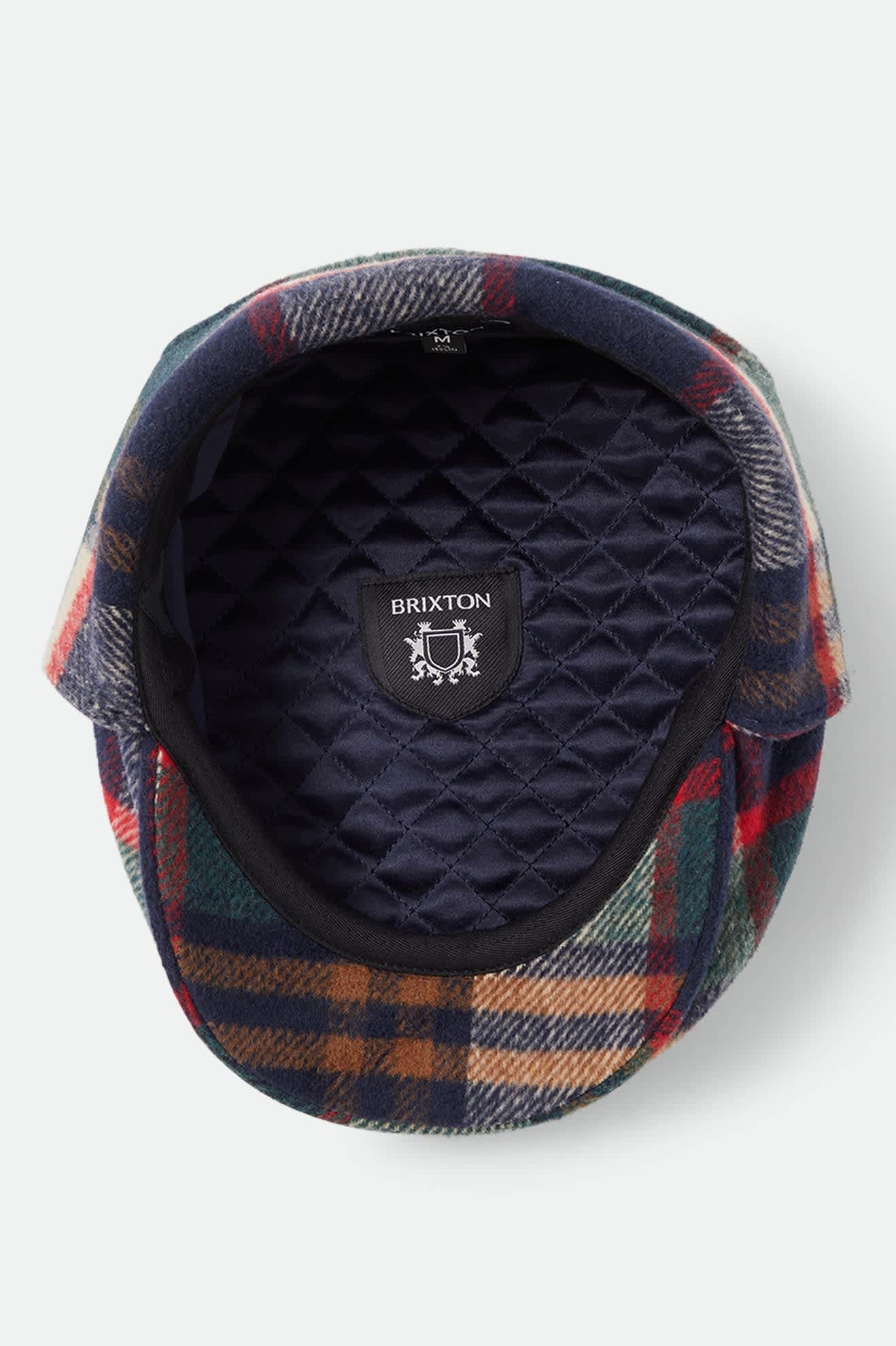 Unisex Barrel Earflap Snap Cap in the color Navy/Green/Red/Cream - Additional Laydown image